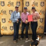 Three people and a dog at Peach State Futurity.